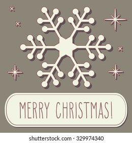 Paper cut snowflake and hand written Christmas greetings over vintage brown background.