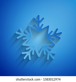 Paper cut Snowflake icon isolated on blue background. Merry Christmas and Happy New Year. Paper art style. Vector Illustration