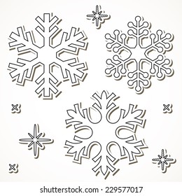 Paper cut snowflakes isolated over white background.
