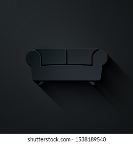Paper cut Sofa icon isolated on black background. Paper art style. Vector Illustration