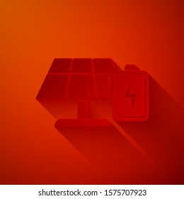 Paper cut Solar energy panel and battery icon isolated on red background. Paper art style. Vector Illustration