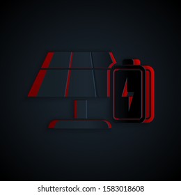 Paper cut Solar energy panel and battery icon isolated on black background. Paper art style. Vector Illustration