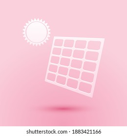 Paper cut Solar energy panel and sun icon isolated on pink background. Paper art style. Vector.