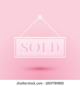 Paper cut Sold icon isolated on pink background. Sold sticker. Sold signboard. Paper art style. Vector.
