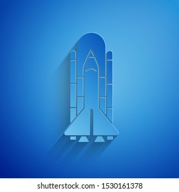Paper cut Space shuttle and rockets icon isolated on blue background. Paper art style. Vector Illustration