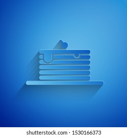 Paper cut Stack of pancakes icon isolated on blue background. Baking with syrup and cherry. Breakfast concept. Paper art style. Vector Illustration