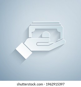 Paper cut Stacks paper money cash in hand icon isolated on grey background. Insurance concept. Money banknotes stacks. Bill currency. Paper art style. Vector