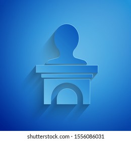 Paper cut Stage stand or debate podium rostrum icon isolated on blue background. Conference speech tribune. Paper art style. Vector Illustration