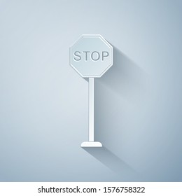 Paper cut Stop icon isolated on grey background. Traffic regulatory warning stop symbol. Paper art style. Vector Illustration