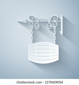 Paper cut Street signboard hanging on forged brackets with barrel shaped wooden icon isolated on grey background. Paper art style. Vector Illustration