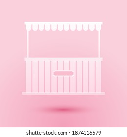 Paper cut Street stall with awning and wooden rack icon isolated on pink background. Kiosk with wooden rack. Paper art style. Vector.