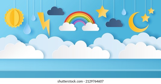 Paper cut of studio table room for product display with weather icons on blue sky background. Origami sun, clouds, drops rain and crescent moon with stars, copy space for baby's