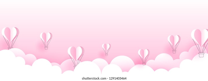 Paper cut style cloudy background with flying hot air balloons illustration for valentine's day header or banner design.