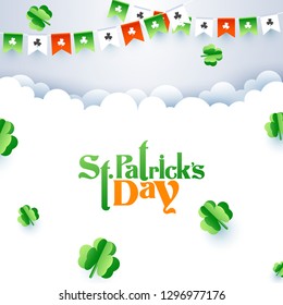 Paper cut style clover leaves on white cloudy background decorated with bunting flags for St Patrick's Day celebration.