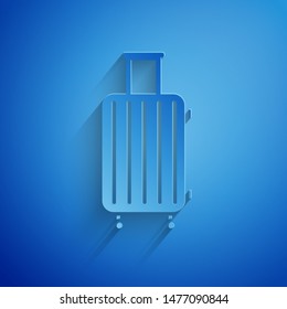 Paper cut Suitcase for travel icon isolated on blue background. Traveling baggage sign. Travel luggage icon. Paper art style. Vector Illustration