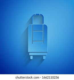 Paper cut Suitcase for travel icon isolated on blue background. Traveling baggage sign. Travel luggage icon. Paper art style. Vector Illustration