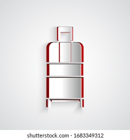 Paper cut Suitcase for travel icon isolated on grey background. Traveling baggage sign. Travel luggage icon. Paper art style. Vector Illustration