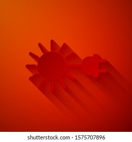 Paper cut Sun with electric plug icon isolated on red background. Energy saving concept. Paper art style. Vector Illustration