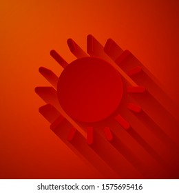 Paper cut Sun icon isolated on red background. Paper art style. Vector Illustration