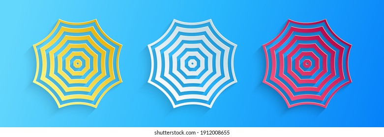 Paper cut Sun protective umbrella beach icon isolated on blue background. Large parasol for outdoor space. Summer vacation or picnic accessory. Paper art style. Vector.