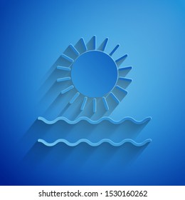 Paper cut Sun and waves icon isolated on blue background. Paper art style. Vector Illustration