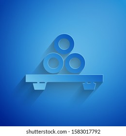 Paper cut Sushi on cutting board icon isolated on blue background. Asian food sushi on wooden board. Paper art style. Vector Illustration