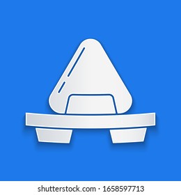 Paper cut Sushi on cutting board icon isolated on blue background. Asian food sushi on wooden board. Paper art style. Vector Illustration