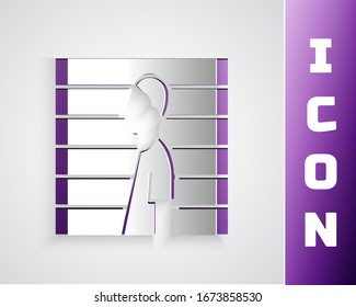 Paper cut Suspect criminal icon isolated on grey background. The criminal in prison, suspected near the board. Paper art style. Vector Illustration