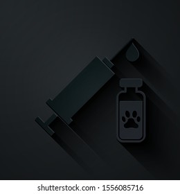 Paper cut Syringe with pet vaccine icon isolated on black background. Dog or cat paw print. Paper art style. Vector Illustration