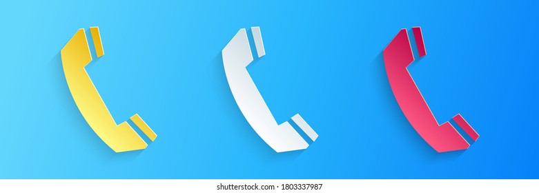 Paper cut Telephone handset icon isolated on blue background. Phone sign. Call support center symbol. Communication technology. Paper art style. Vector.