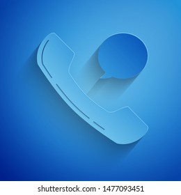 Paper cut Telephone handset and speech bubble chat icon isolated on blue background. Phone sign. Paper art style. Vector Illustration