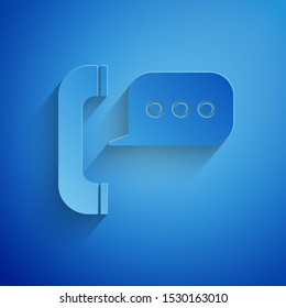 Paper cut Telephone with speech bubble chat icon isolated on blue background. Support customer service, hotline, call center, faq, maintenance. Paper art style. Vector Illustration