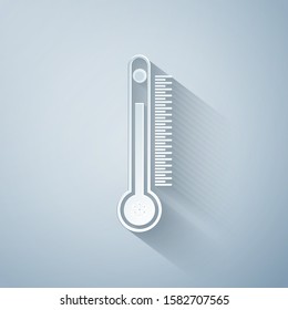 Paper cut Thermometer with scale measuring heat and cold, with sun and snowflake icon isolated on grey background. Paper art style. Vector Illustration