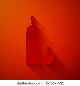 Paper cut Thermos container icon isolated on red background. Thermo flask icon. Camping and hiking equipment. Paper art style. Vector Illustration