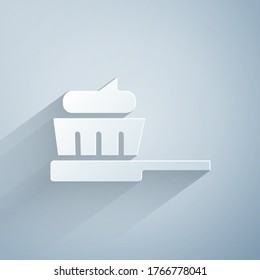 Paper cut Toothbrush with toothpaste icon isolated on grey background. Paper art style. Vector Illustration