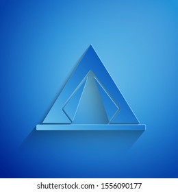 Paper cut Tourist tent icon isolated on blue background. Camping symbol. Paper art style. Vector Illustration