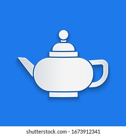 Paper cut Traditional Chinese tea ceremony icon isolated on blue background. Teapot with cup. Paper art style. Vector Illustration