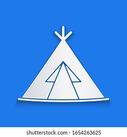 Paper cut Traditional indian teepee or wigwam icon isolated on blue background. Indian tent. Paper art style. Vector Illustration