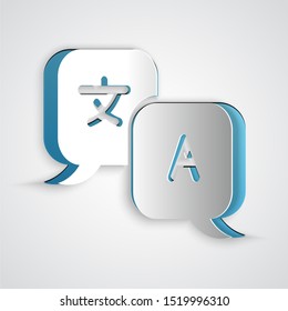 Paper cut Translator icon isolated on grey background. Foreign language conversation icons in chat speech bubble. Translating concept. Paper art style. Vector Illustration
