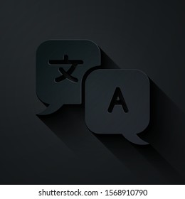 Paper cut Translator icon isolated on black background. Foreign language conversation icons in chat speech bubble. Translating concept. Paper art style. Vector Illustration