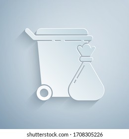 Paper cut Trash can and garbage bag icon isolated on grey background. Garbage bin sign. Recycle basket icon. Office trash icon. Paper art style. Vector Illustration