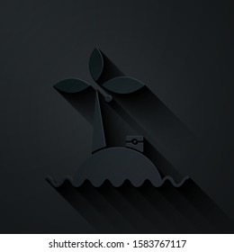 Paper cut Tropical island in ocean icon isolated on black background. Landscape with ocean and palm trees. Travel. Paper art style. Vector Illustration