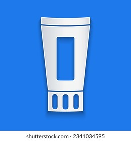 Tubo de corte de papel del ícono de pasta dental aislado en fondo azul. Estilo de arte de papel. Vector