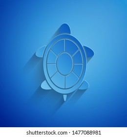 Paper cut Turtle icon isolated on blue background. Paper art style. Vector Illustration
