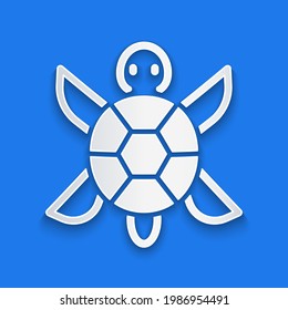 Paper cut Turtle icon isolated on blue background. Paper art style. Vector