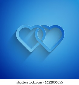 Paper cut Two Linked Hearts icon isolated on blue background. Romantic symbol linked, join, passion and wedding. Valentine day. Paper art style. Vector Illustration