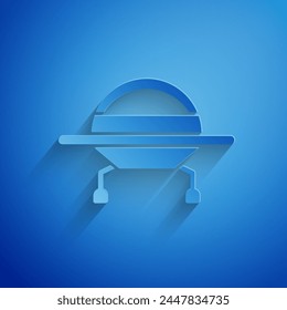 Paper cut UFO flying spaceship icon isolated on blue background. Flying saucer. Alien space ship. Futuristic unknown flying object. Paper art style. Vector Illustration