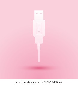 Paper cut USB cable cord icon isolated on pink background. Connectors and sockets for PC and mobile devices. Smartphone recharge supply. Paper art style. Vector.