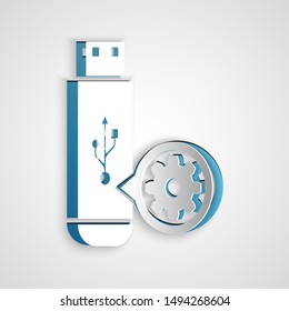 Paper cut USB flash drive and gear icon isolated on grey background. Adjusting app, service concept, setting options, maintenance, repair, fixing. Paper art style. Vector Illustration
