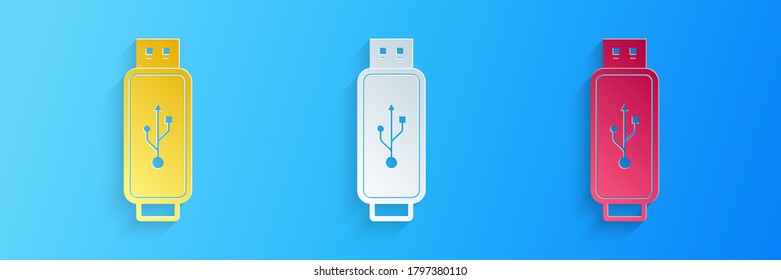 Paper cut USB flash drive icon isolated on blue background. Paper art style. Vector.